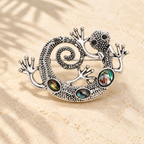 Curled Gecko with Iridescent Inlays Brooch — styled background