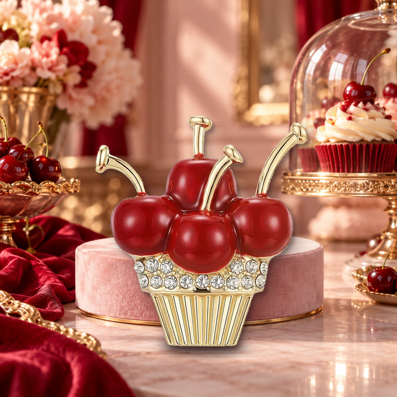 Cherry Topped Rhinestone Cupcake Brooch styled in a thematic scene