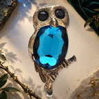 Faceted Owl on Branch Brooch on an elegant ivory, deep green and gold background