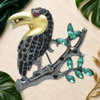 Jeweled Toucan on Leafy Branch Brooch on an elegant ivory, evergreen and gold tropical background
