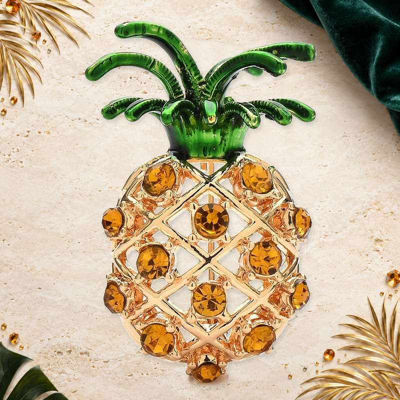 Rhinestone Pineapple with Enamel Leaves Brooch on an ivory, evergreen and gold gallery background
