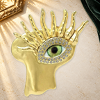 Sculptural Face with Eye Motif Brooch on a complementary display background