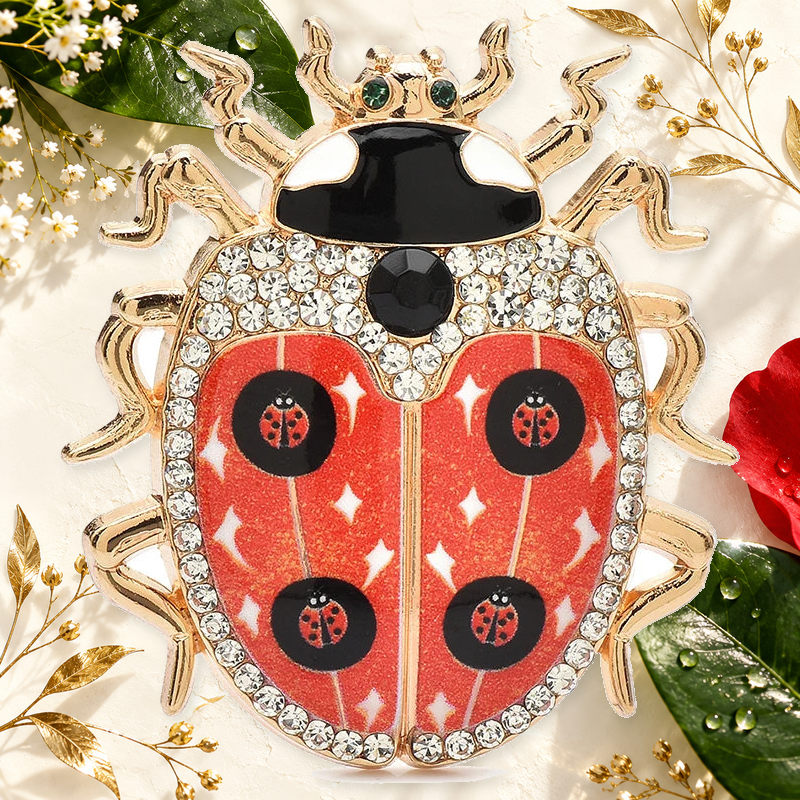 Star-Patterned Rhinestone Ladybug Brooch on an elegant ivory, deep green and gold background