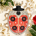 Star-Patterned Rhinestone Ladybug Brooch on an elegant ivory, deep green and gold background