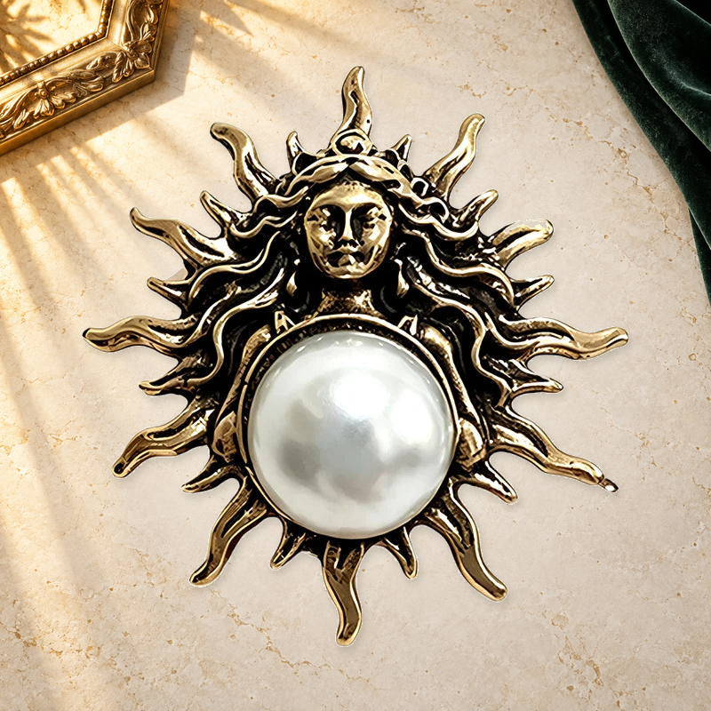 Sun Goddess with Pearl-Look Accent Brooch on an ivory themed backdrop